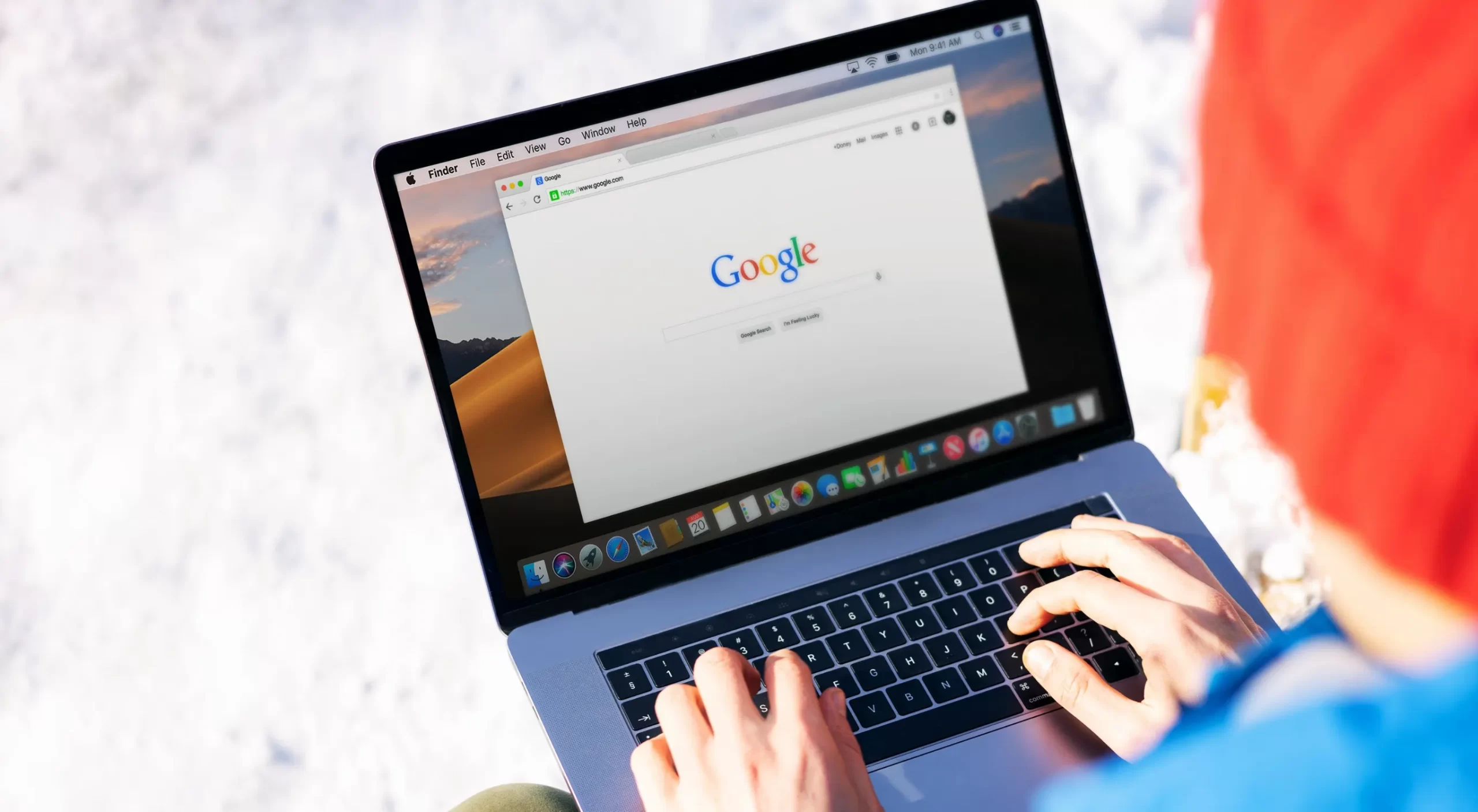 Man working on computer with Google browser in winter